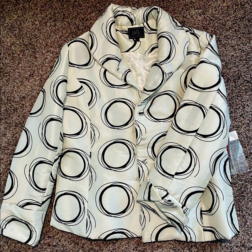 Cream and black water repellent dress jacket.